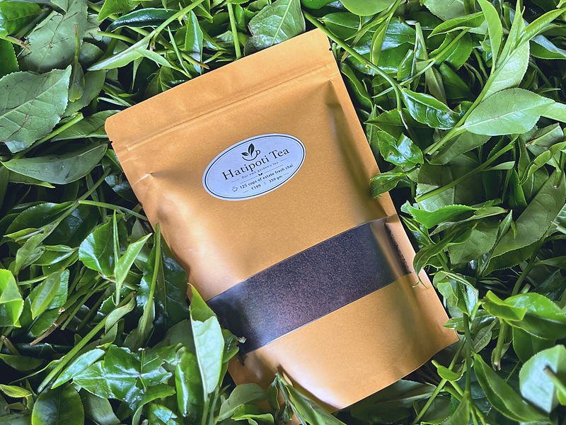 A pack of Hatipoti Assam CTC tea on freshly plucked leaf